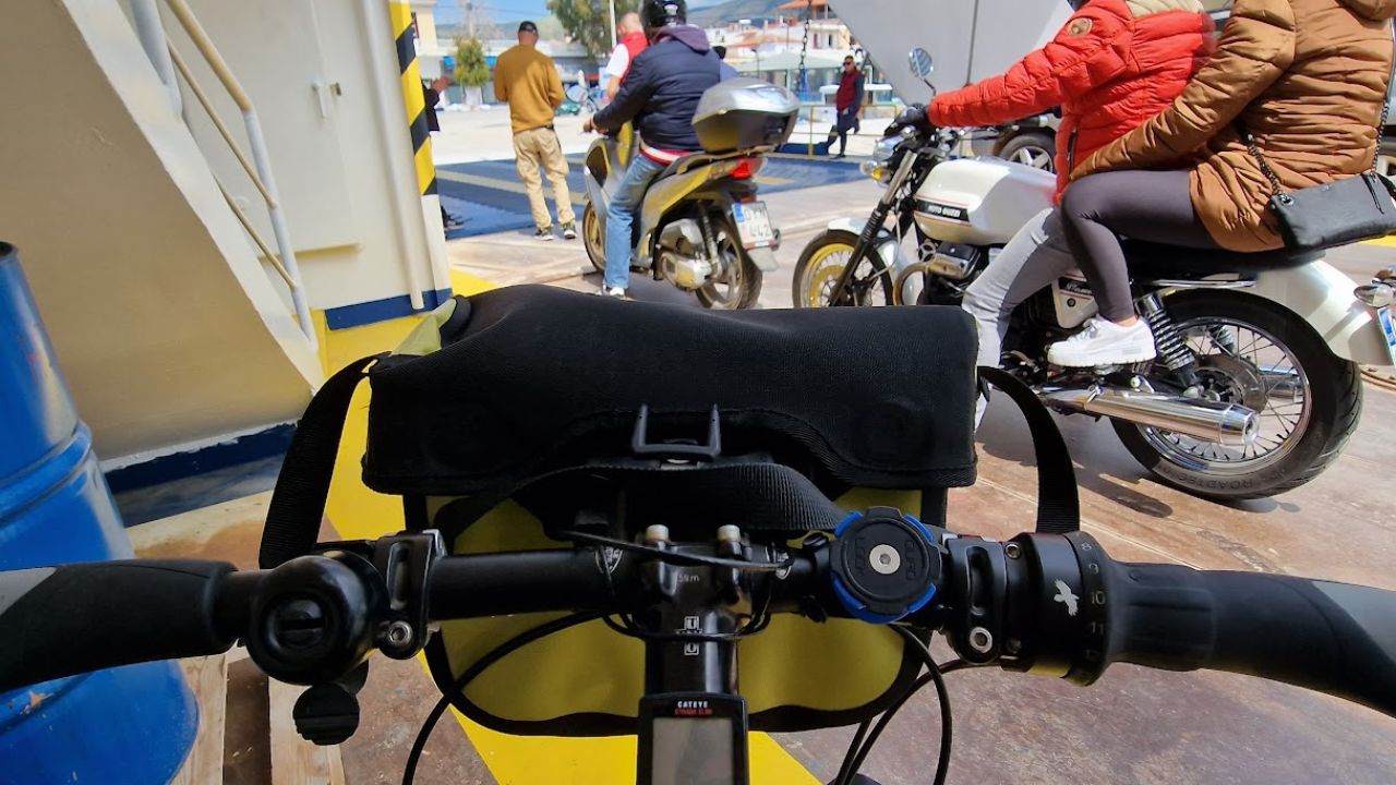 view from a bicycle on the ferry vehicle deck with motorbikes ahead as the ferry unloads