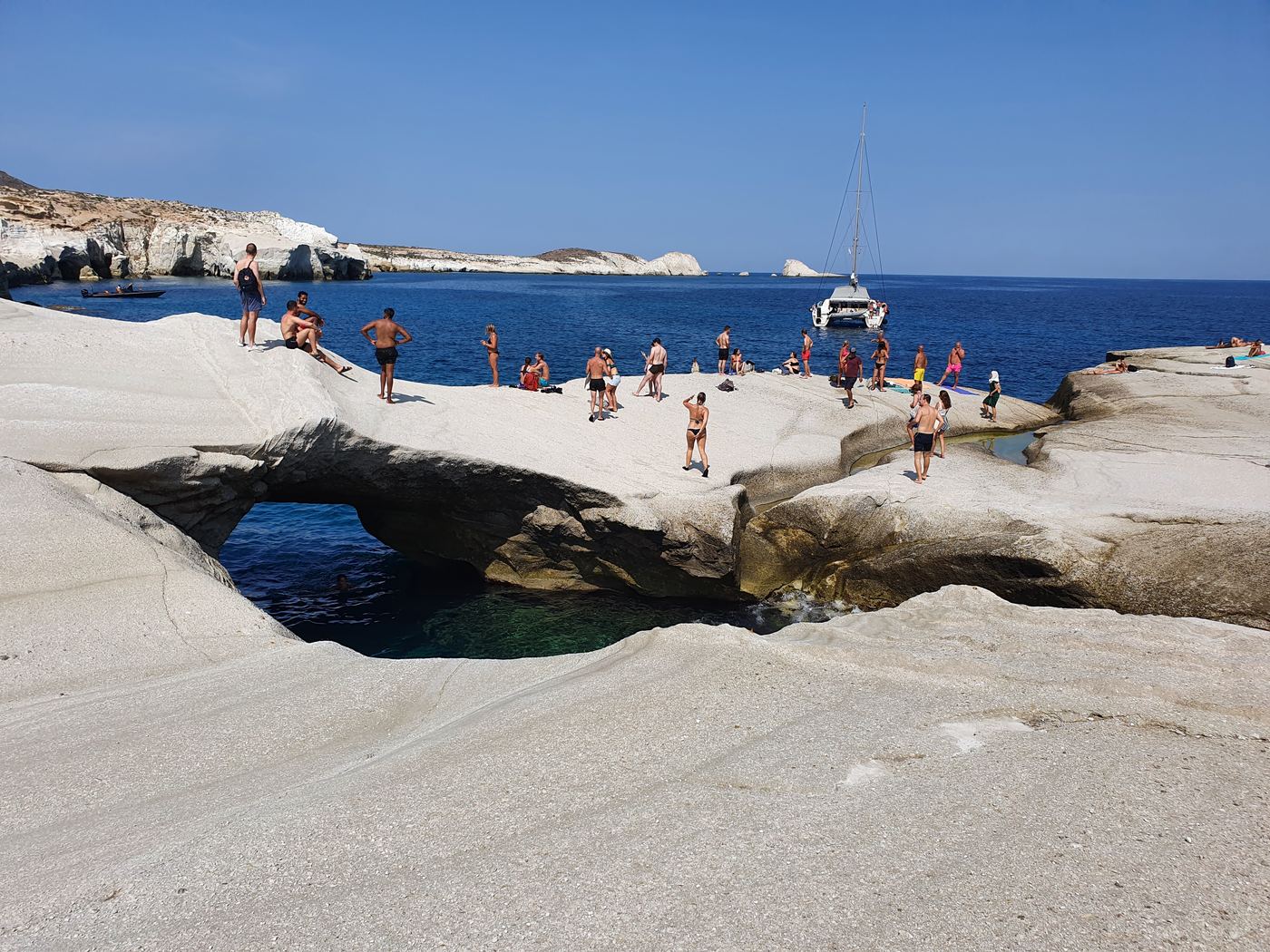 a large white rock formation next to a body of water